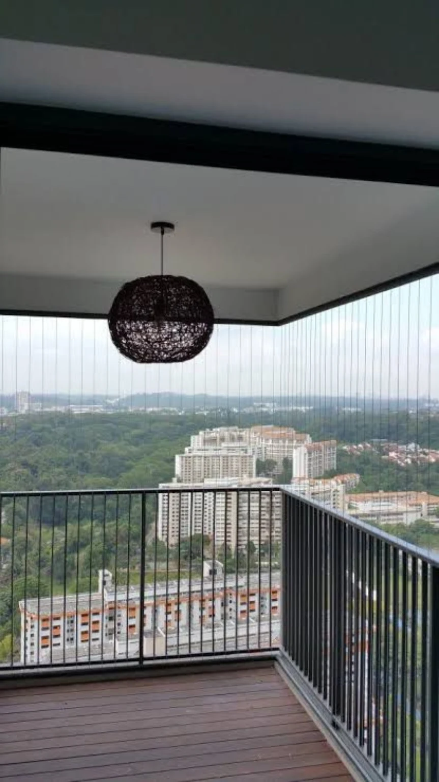 Invisible stainless steel safety cables installed across a high-rise balcony