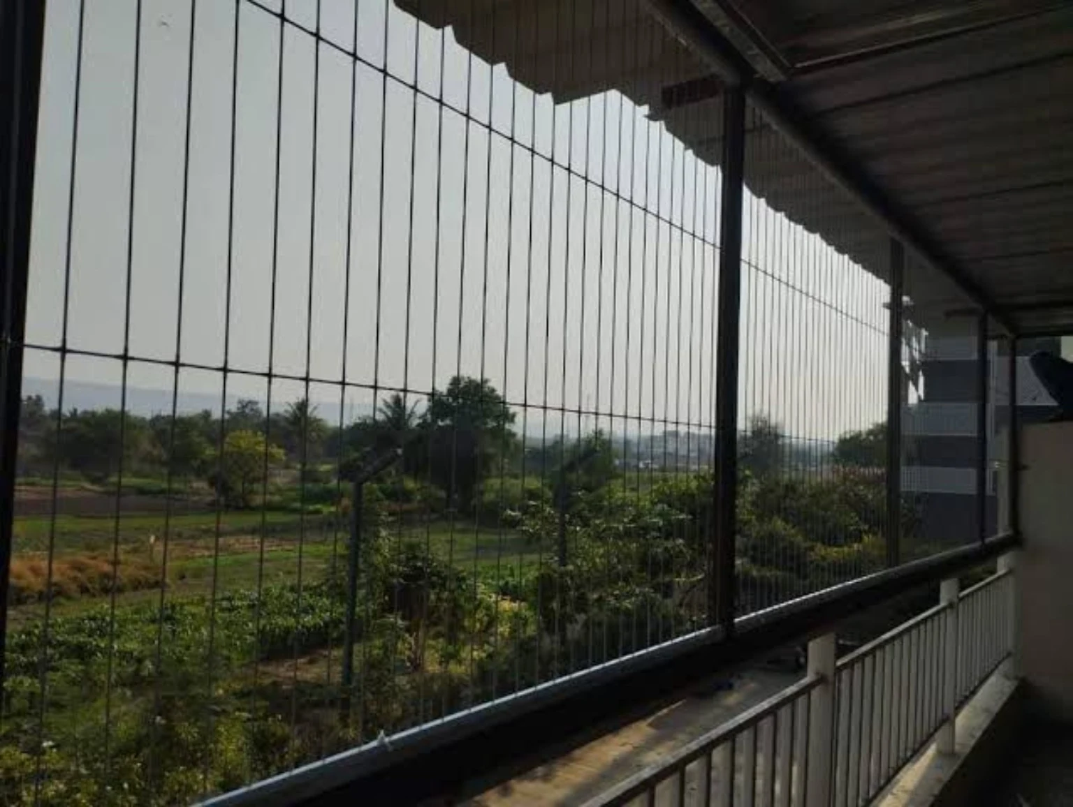 Long balcony protected with vertical invisible stainless steel safety cables