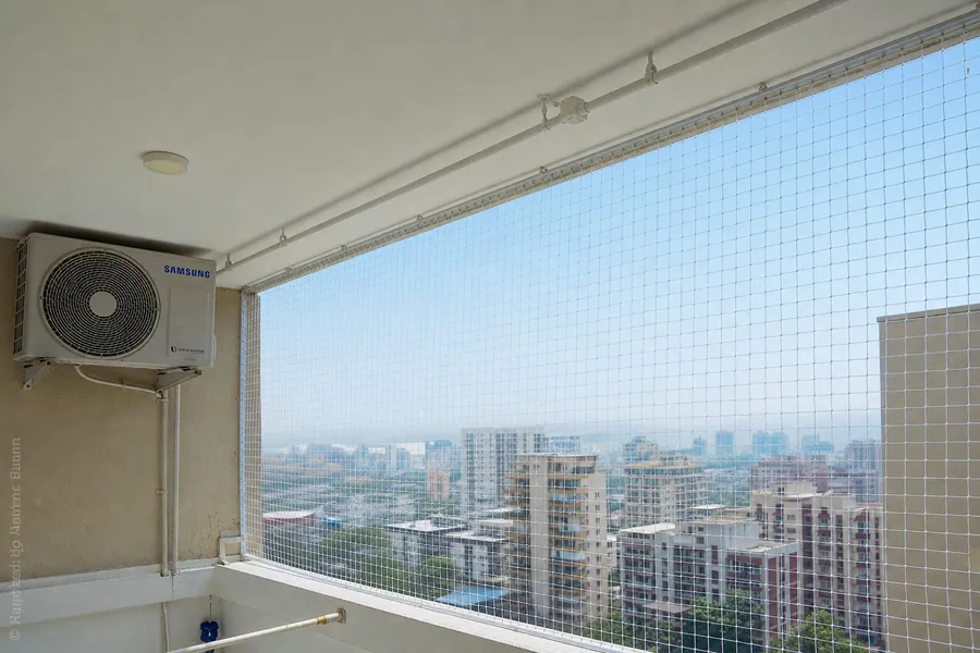 Bird protection net installed on an apartment balcony in Navi Mumbai